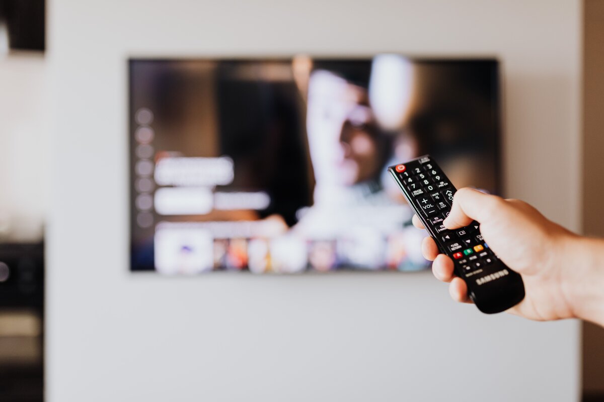 Hand holding remote control for Firestick
