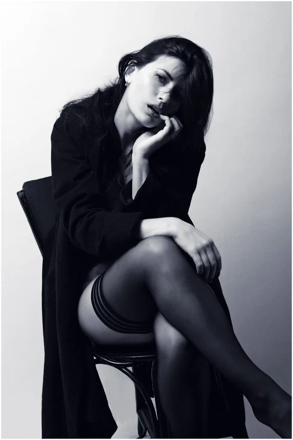 Woman in black blazer sitting on black chair